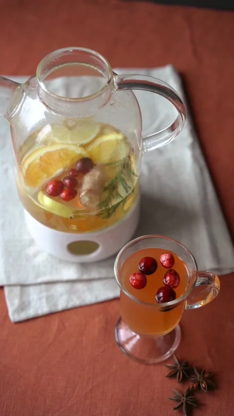 Cozy Hot Fruit Infusion Tea with Cranberries and Orange Stock Footage 344016124