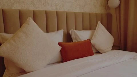Cozy Hotel Bedroom with Comfortable Bedding and Soft Lighting Stock Footage 346044136