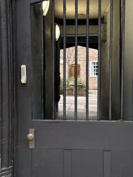 Cozy inner yard seen through the metal gate door Stock Photos