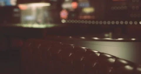 Cozy interior of a lounge with dim lighting in an urban setting at night 库存插图