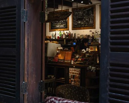 Cozy interior view of a local coffee shop counter through open wooden window Stock Photos