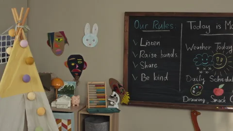 Cozy Kindergarten Classroom Interior with Teepee Tent and Chalkboard Stock Footage 332324142