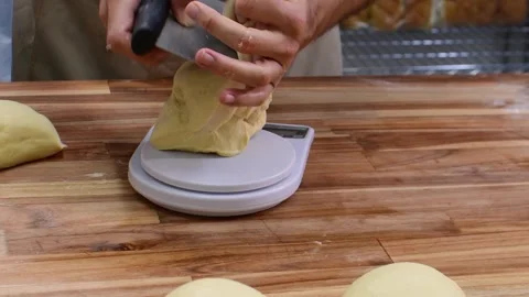 Cozy Kitchen Baking: Hand Weighs Dough on Scale for Bread Preparation Stock Footage 332567542