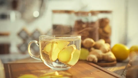 In a cozy kitchen bathed in sunlight a mans hand grasps a spoon to stir stea Stock Footage 331352970