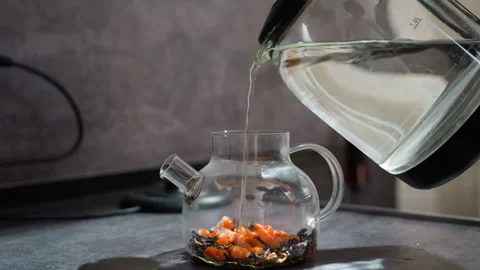 Cozy Kitchen Tea Preparation, Hot Water Fills Glass Teapot As Berries Settle Stock Footage 329479855