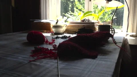 Cozy Knitting Project With Yarn and Needles on Table Near Sunny Window Stock Footage 328142157