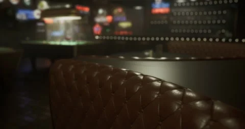 Cozy leather seating in a dimly lit lounge with pool table in background Stock Footage 317777796