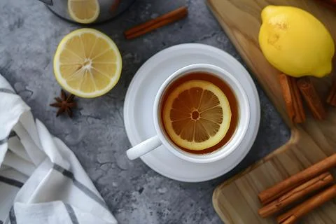 Cozy lemon tea cup on rustic table Stock Photos