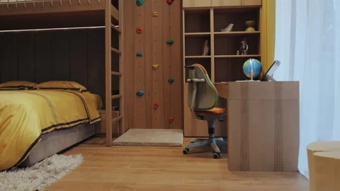 A Cozy Modern Bedroom featuring a Climbing Wall and a wellstructured Study Area Stock Footage 287732011