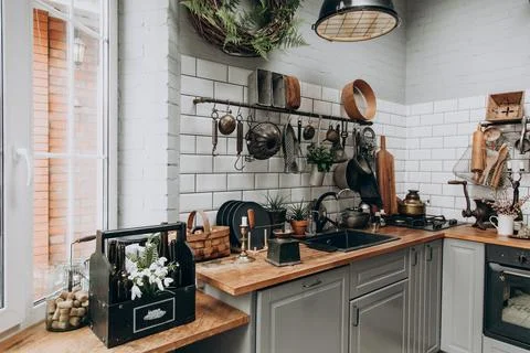Cozy modern kitchen with rustic elements and natural light from the window Stock Photos