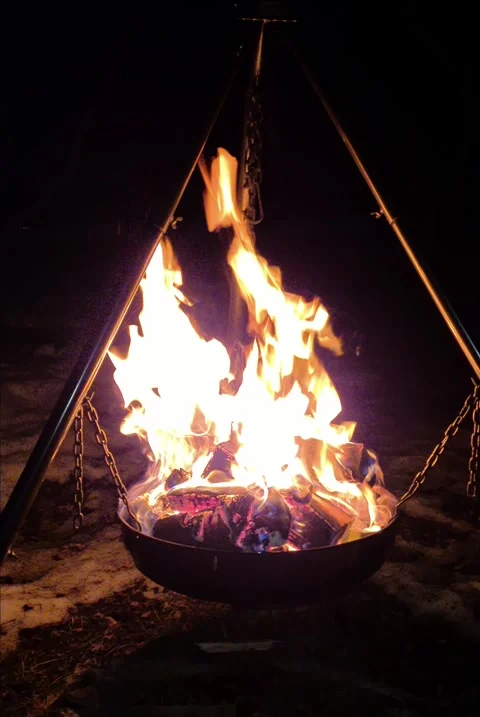 Cozy Night Campfire in a Tripod Fire Pit Stock Footage 280990415