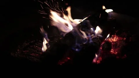 A cozy night at the home backyard firepit with a blazing wood fire with Stock Footage 238741645