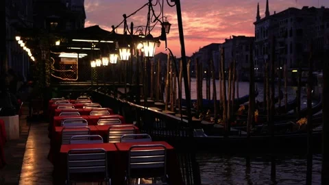 Cozy outdoor cafe with red tableclothes against sunset Video stock 142843596