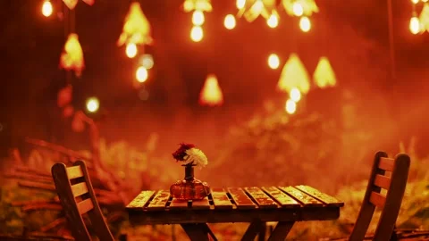 Cozy outdoor cafe table set with flowers and string lights at night for rom.. Stock-Footage 339653827