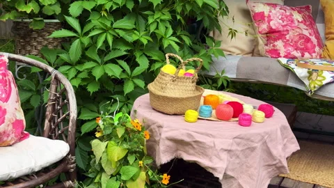 A cozy outdoor corner for creativity in a summer garden: a cushioned swing serve Video stock 311475094