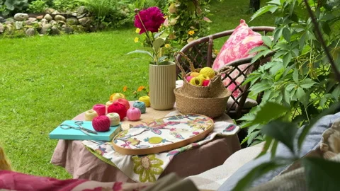 A cozy outdoor corner for creativity in a summer garden: a cushioned swing serve 스톡 동영상 311475483