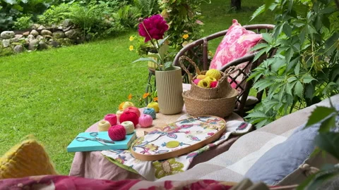 A cozy outdoor corner for creativity in a summer garden: a cushioned swing serve Stock Footage 311475569