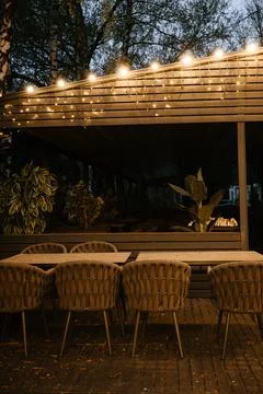 Cozy Outdoor Dining Area with String Lights Stock Photos