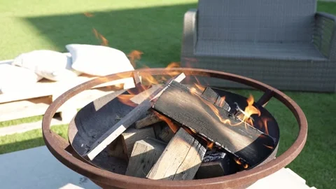 Cozy Outdoor Fire Pit Burning with Bright Flames in Backyard Garden Stock Footage 339067927