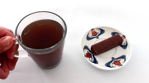 Cozy Pause: Tea and Chocolate Bar in a Serene White Setting Video stock 319004078