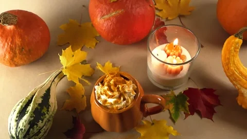 Cozy pumpkin spice latte with burning candles and gourds Stock Footage 346594815