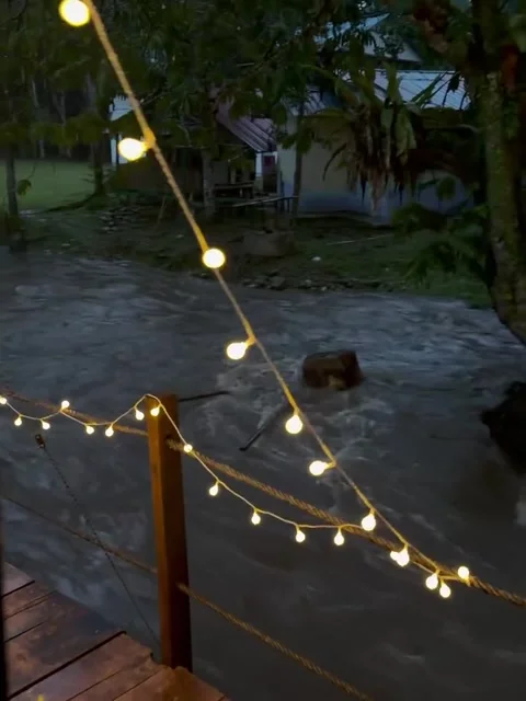 Cozy Rainy Night Camping Setup Overlooking a Swollen River Video stock 341317732