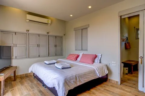 Cozy rustic bedroom with comfortable bed and wooden furniture Photos