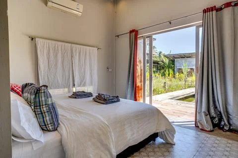 Cozy rustic bedroom with comfortable bed and wooden furniture 스톡 사진