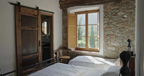 Cozy rustic bedroom interior in a countryside stone house Stock Footage 340484519