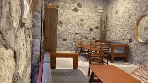 Cozy Rustic Cafe Interior with Exposed Stone Wall and Arched Window View Stock Footage 318569282
