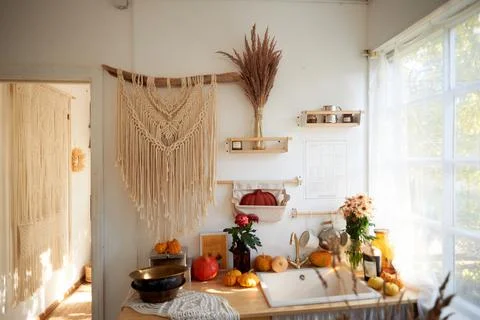 Cozy rustic kitchen with large window and lace curtains. On the wall hangs a Stock Photos