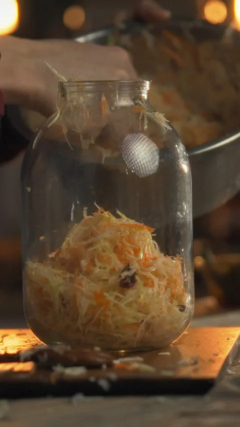 In a cozy rustic kitchen a person manually prepares traditional fermented fo Stock Footage 334397726