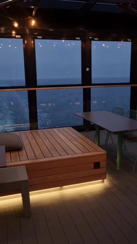 A cozy seating area on a ferry with warm lighting and plants Stock-Footage 307635496