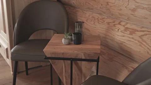 Cozy seating area with stylish leather chairs and a wooden table against a Stock-Footage 334712326