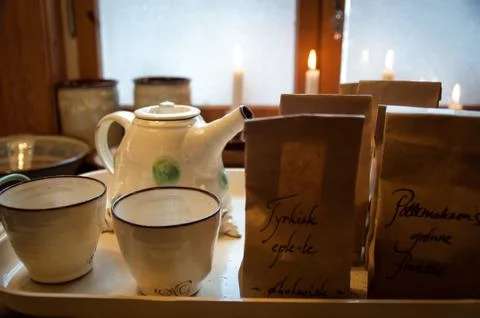 Cozy serving tray with ceramic teacups, teapot, tea and candles Stock Photos