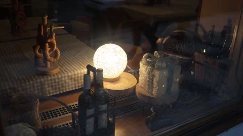 Cozy shop window with warm lamp Stock Footage 323700903