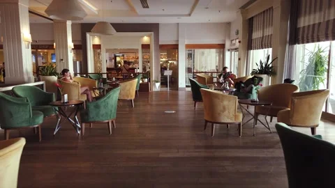 Cozy small hotel lobby with seating and tables. Video stock 167019077