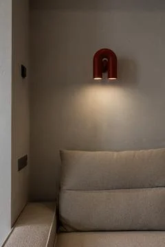 Cozy sofa corner with red wall light Stock Photos