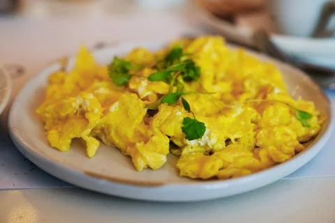 A Cozy Soft Focus Scrambled Egg Breakfast Plate with Herbs on a Table Stock Photos
