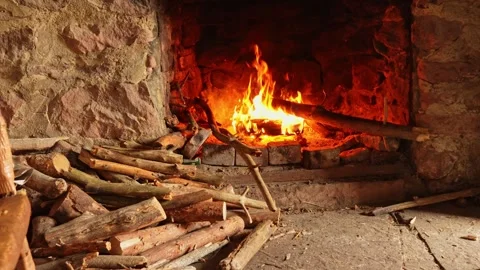 Cozy stone fireplace with burning logs Stock Footage 324923113