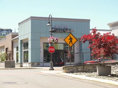 Cozy street corner at Point Ruston with a local shop entrance, stop sign, a.. 스톡 사진