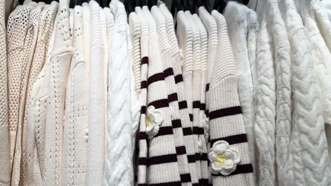 Cozy White Knit Sweaters Hanging Neatly Inside Minimal Modern Wardrobe Closet Video stock 335193145