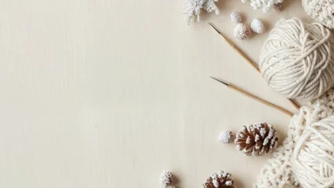 Cozy Winter Knitting Scene With Yarn and Pine Cones on Wooden Background Stock Footage 294507192