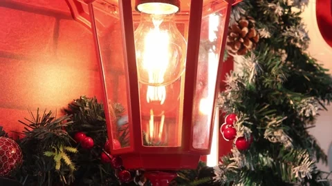 Cozy winter lantern illuminating festive decorations with seasonal charm 스톡 동영상 296145346