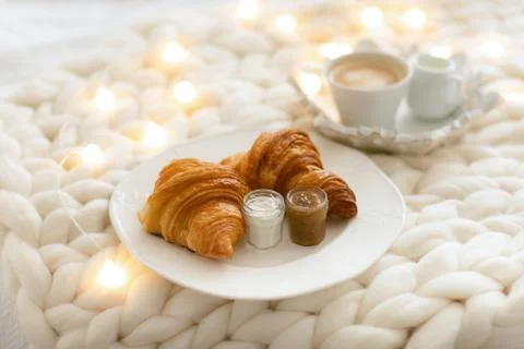 Cozy winter morning at home with coffee and fresh croissant. Stock Photos