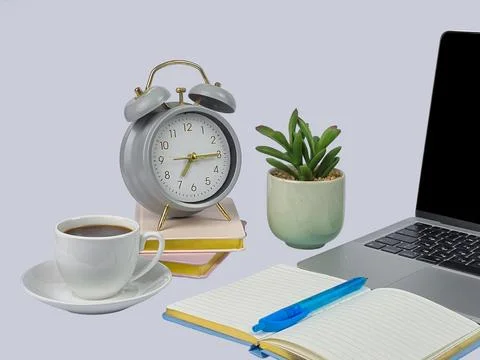 Cozy Workspace Setup with a Stylish Clock, Fresh Coffee, and a Green Plant .. Stock Photos