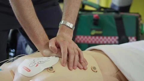 CPR Chest Compressions on Medical Training Manikin During Emergency Response Stock Footage 337690807