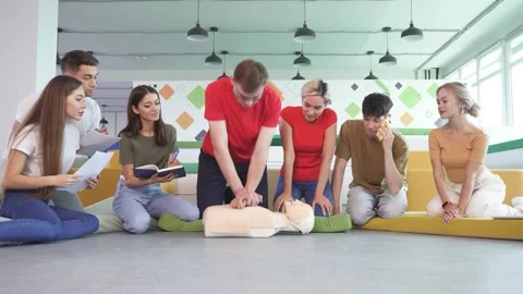 CPR class with male instructor speaking and demonstrating help, giving lessons Stock Footage 146258854