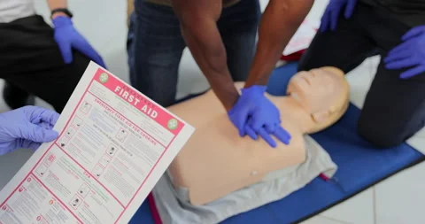 CPR First Aid training concept. Back view of woman holding first aid instruction Stock Footage 163974314