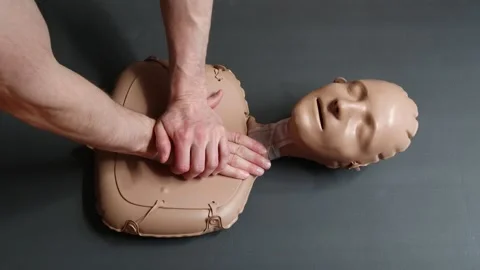 CPR on practice doll. Stock Footage 253075042